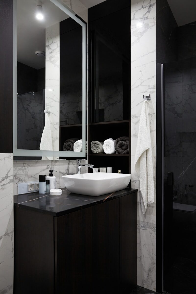 Modern bathroom with marble and black vanity