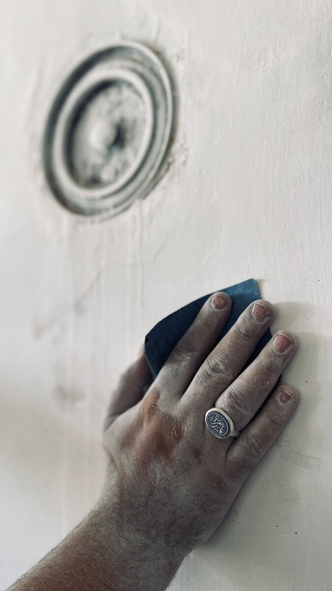 a person's hand with a painted toenail