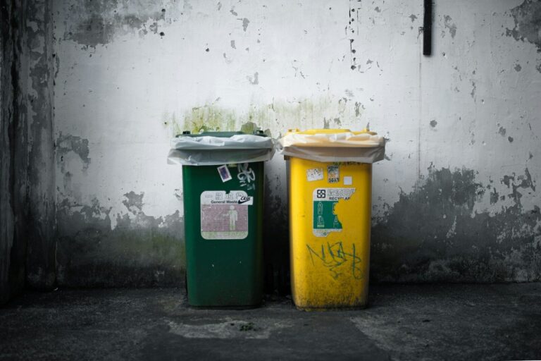 a couple of trash cans sitting next to each other
